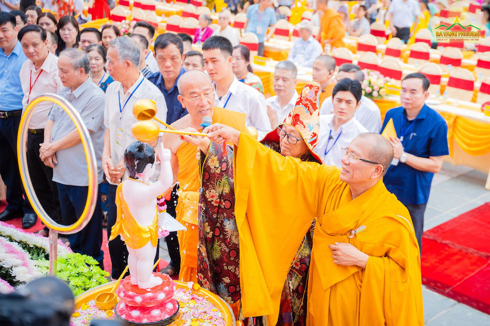 The Sangha performs ritual of offering water to bathe the Buddha