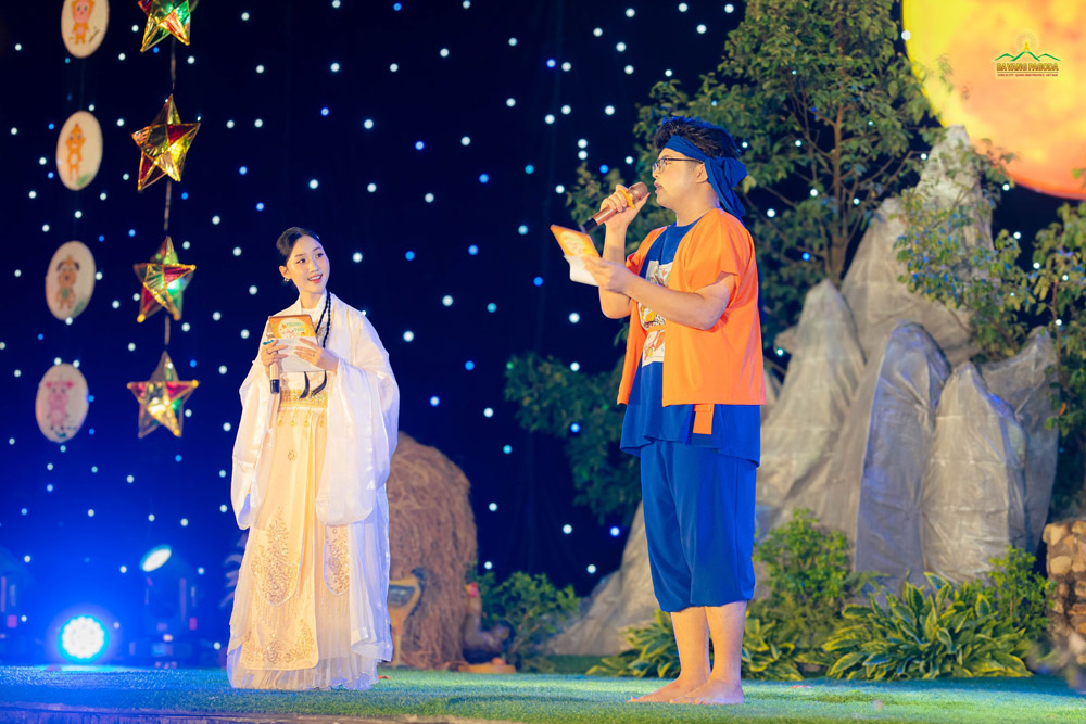 The two MCs are dressed up as the woodcutter and the Moon lady, the two iconic figures during the Mid-Autumn celebration