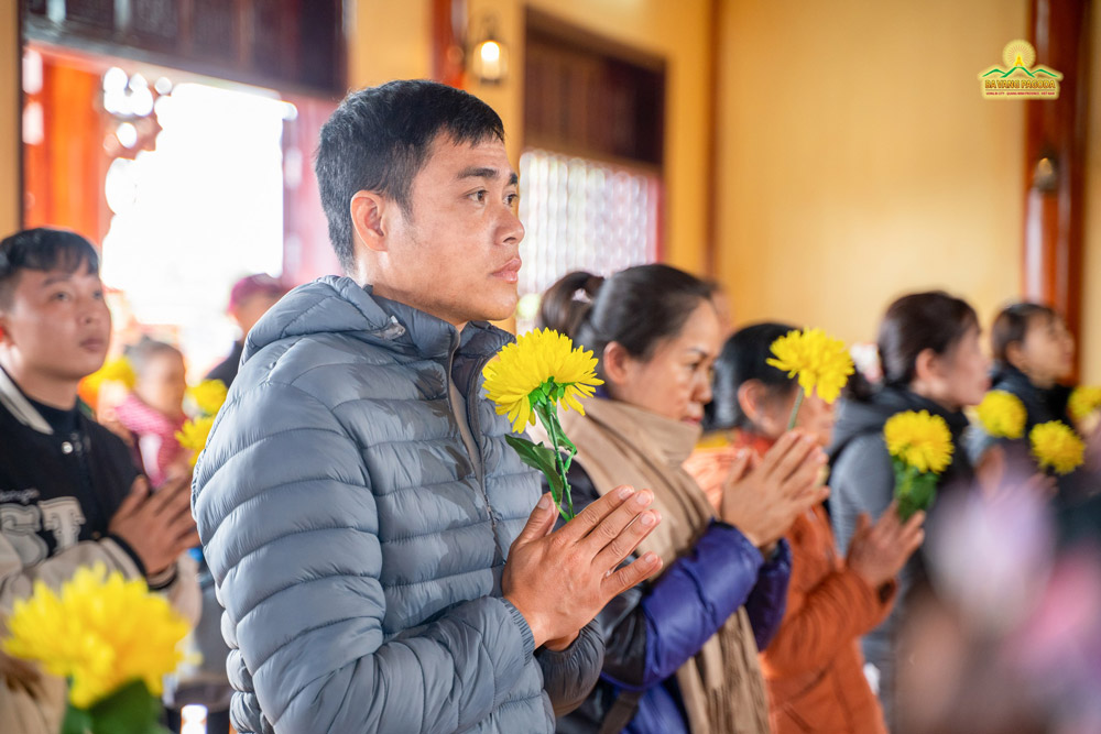 Buddhists solemnly joined their hands, following the ceremony