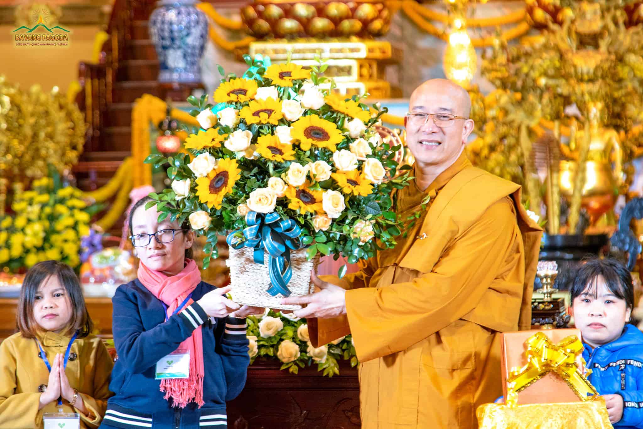 A representative of Nghị Lực Sống (Resolution to live) - the Center of Enhancing the ability of the disabled offering flowers to the Three Jewels.