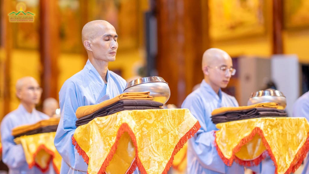 New Monks and Nuns receiving offered robes and alm bowls.