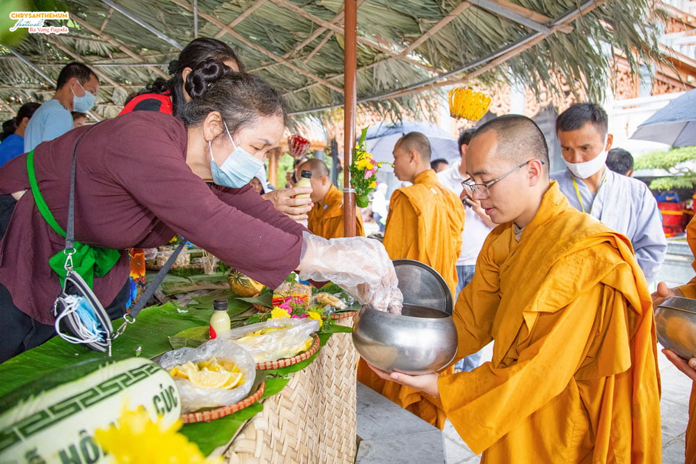 Almsgiving at the miniature of Vietnammese countryside market.