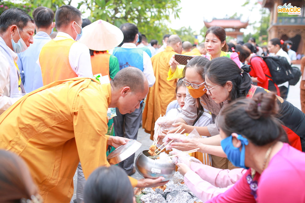 Lay Buddhists giving alms to Monks