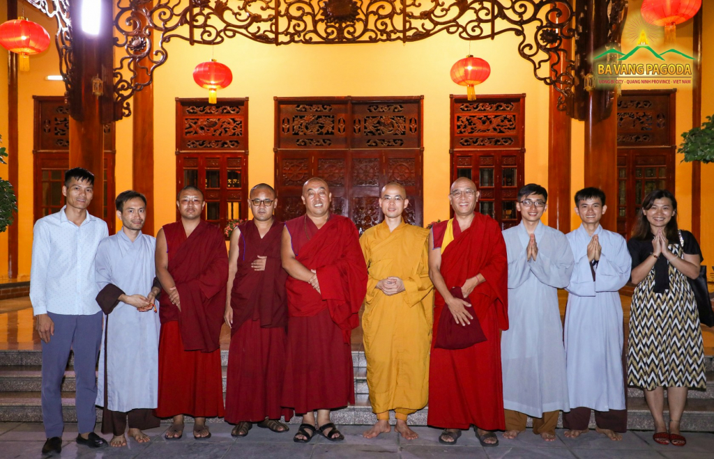 Rinpoche taking a photo with Monks and Buddhists