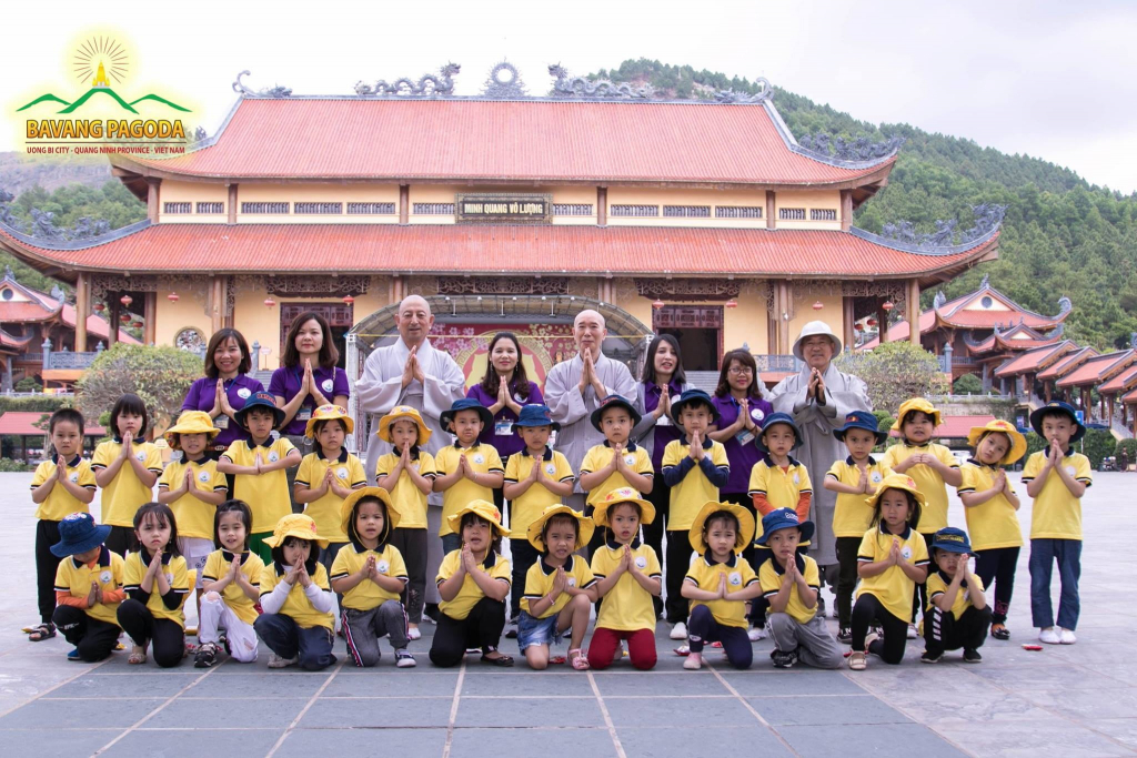 Monks of the Korean Buddhist Taego Order taking a photo with local children from a kindergarten.