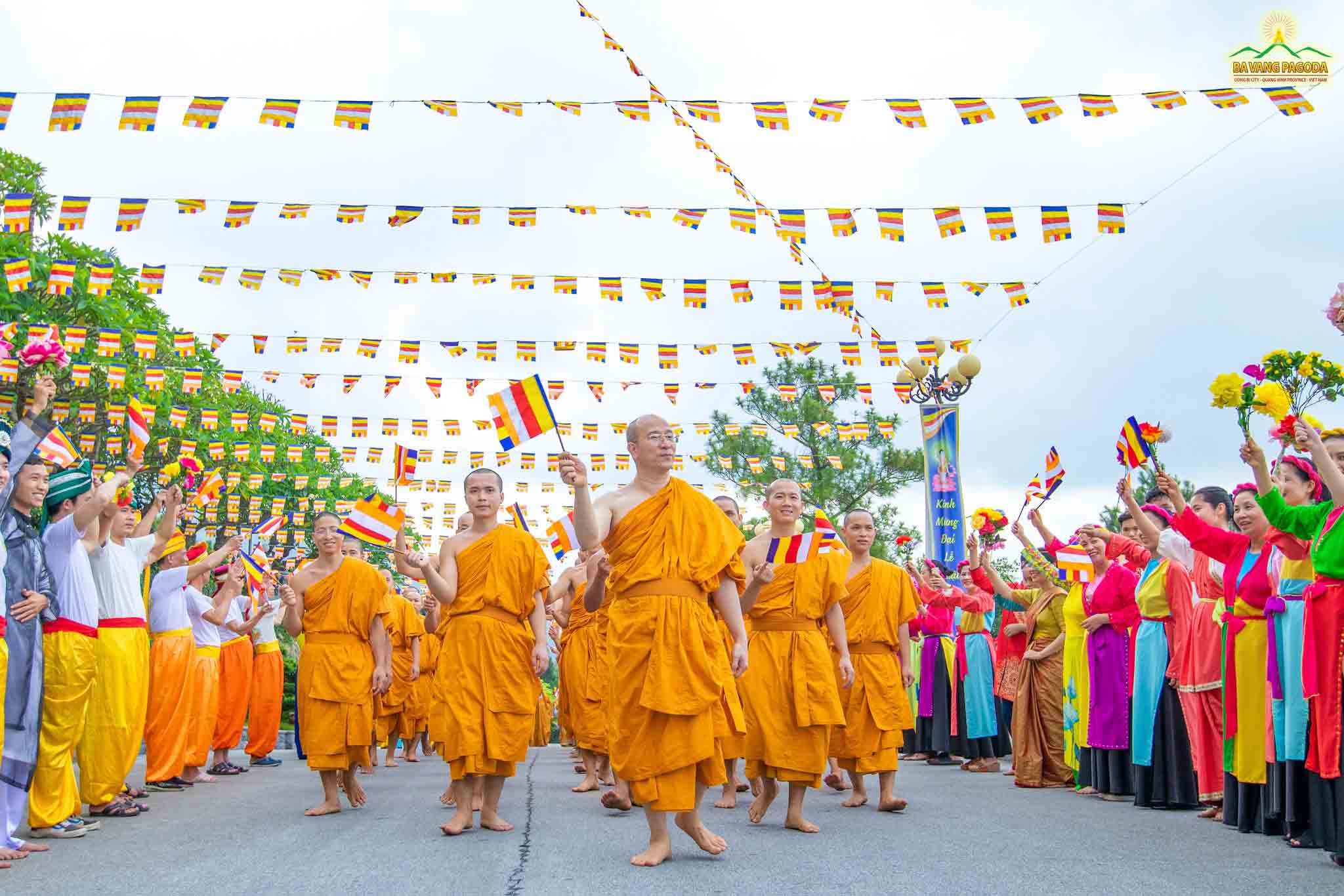 Thay and the Sangha and lay Buddhists happily waving Buddism flag in VESAK celebration 2022 at Ba Vang Pagoda